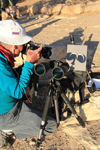 Rangers in Grand Canyon National Park use eclipse filters on a pair of binoculars during an annular eclipse viewing in 2012.
