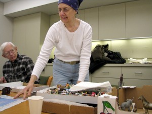 PHOTO: Volunteer Becky Maganuco with a box of miniatures.