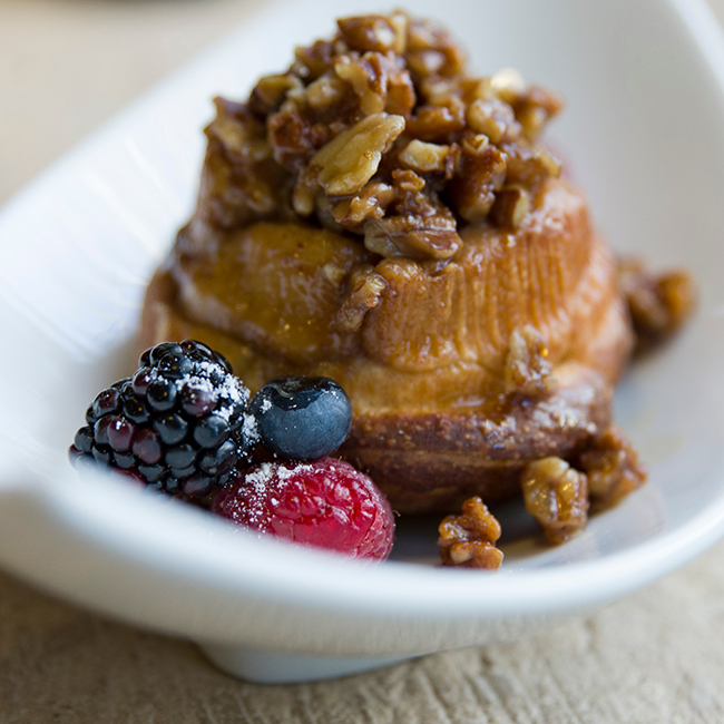PHOTO: Cinnamon sticky bun topped with pecans and fresh berries.