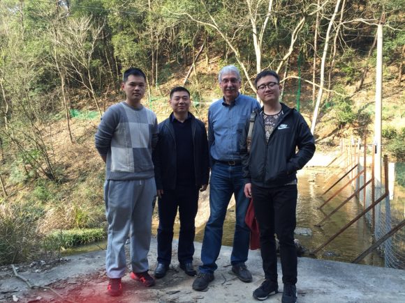 Collaborators tour a study site in China.