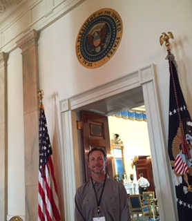 PHOTO: Jim O'Malley under the presidential seal at the door to the Blue Room in the White House.