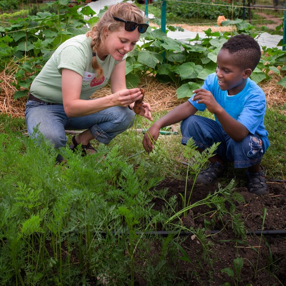 PHOTO: A young boy learns some urban agriculture skills with Windy City Harvest.