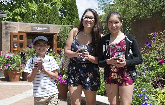 Military family holding small terrariums made at the Garden.