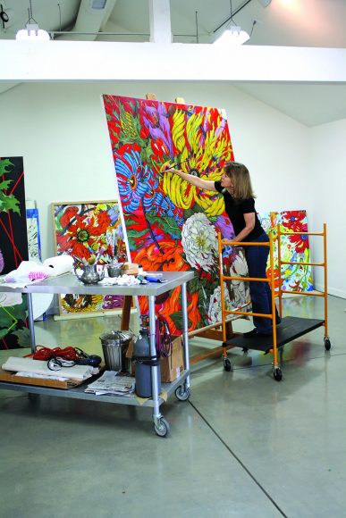 Gottlieb works on one of the Extinct Botanicals canvases in her studio.