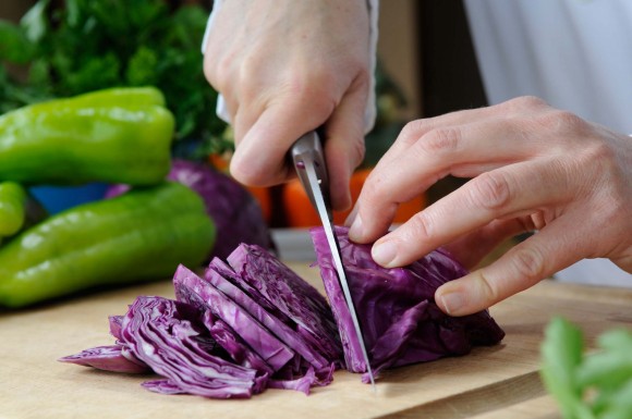 PHOTO: Chef slicing fresh cabbage.