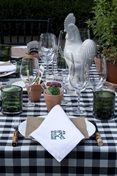 Fresh herbs, terra cotta pots and seed packets grace the table top for a summer pizza party at Boxwood, the Atlanta residence of Danielle Rollins.