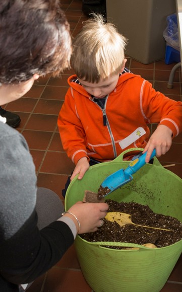 PHOTO: A low, wide trug full of soil makes filling pots easy for younger gardeners.