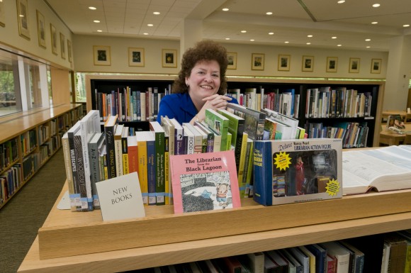 PHOTO: Stacy Stoldt organizing bookshelves.