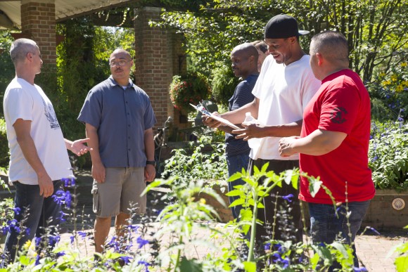PHOTO: Vets gather in the garden, discussing plans.