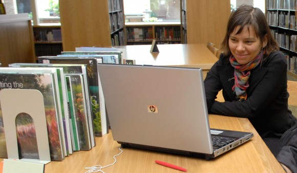 PHOTO: Woman with laptop in the Lenhardt Library.