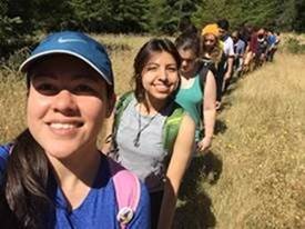 PHOTO: Erica and her fellow students, loaded with backpacks, are hiking up a trail.