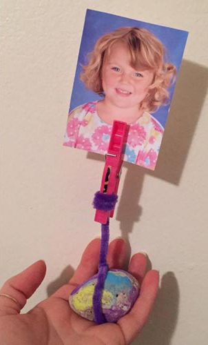 PHOTO: A photo holder made from a painted stone, clothespin, and colorful pipe cleaner.