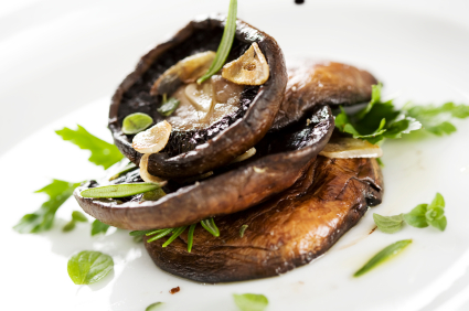 PHOTO: grilled portobello mushrooms, covered in herbs and garlic.